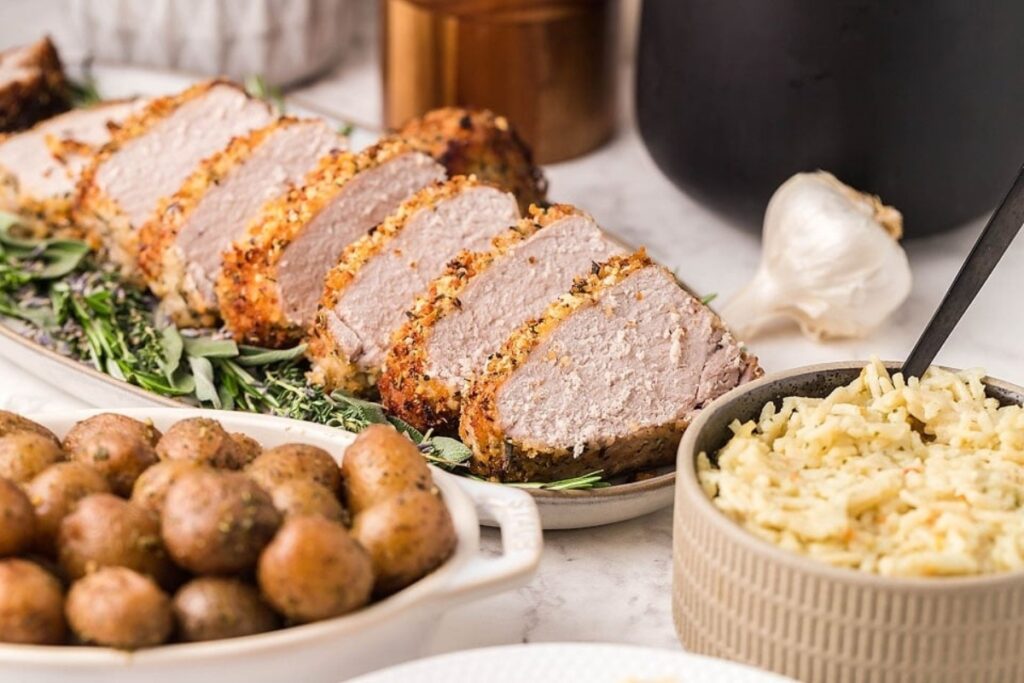 Herb crusted pork on a plate.