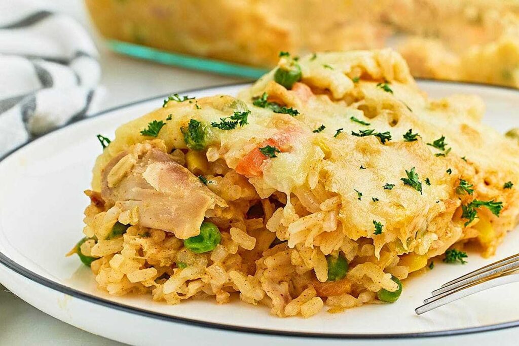 Chicken and rice casserole on a plate with a fork.
